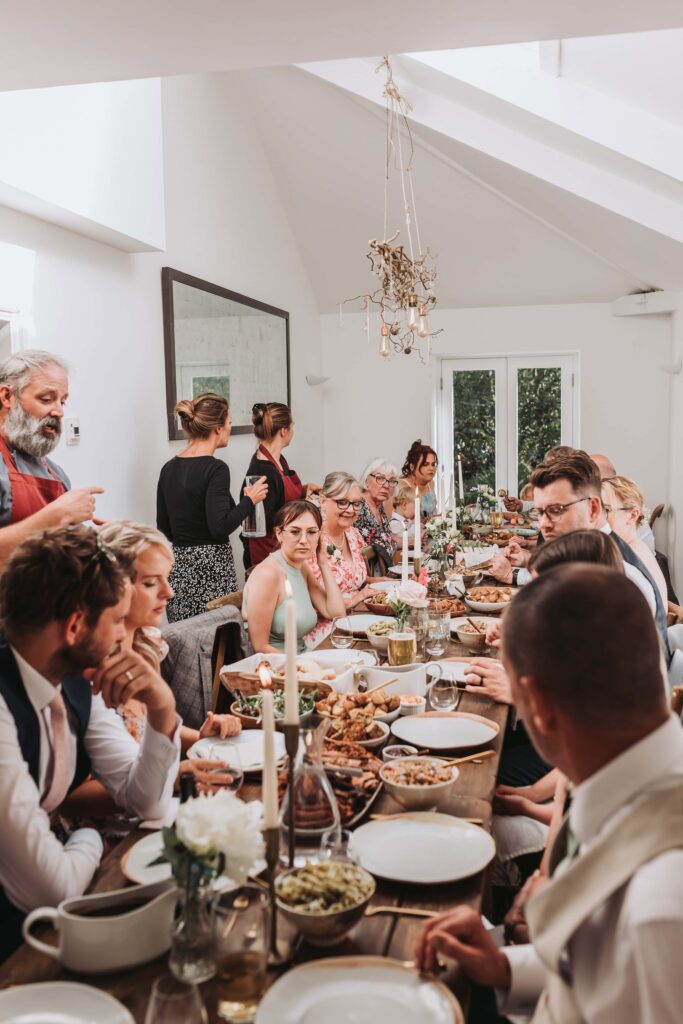 wedding guests sitting down for food at treseren