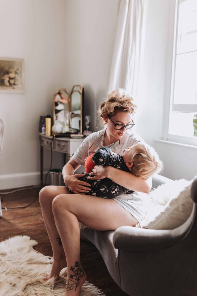 bride holding son on wedding mornign