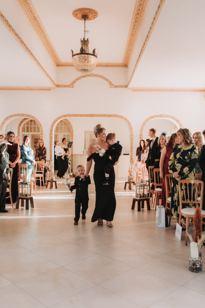 bridesmaid and children walking down the aisle