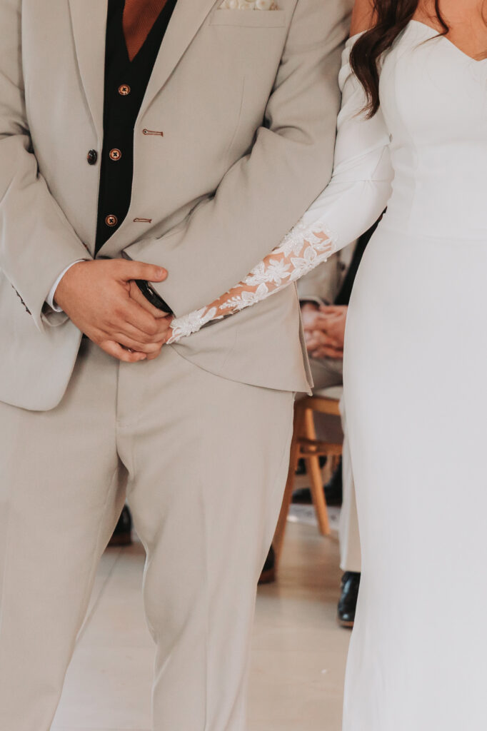 bride and groom holding hands during wedding ceremony