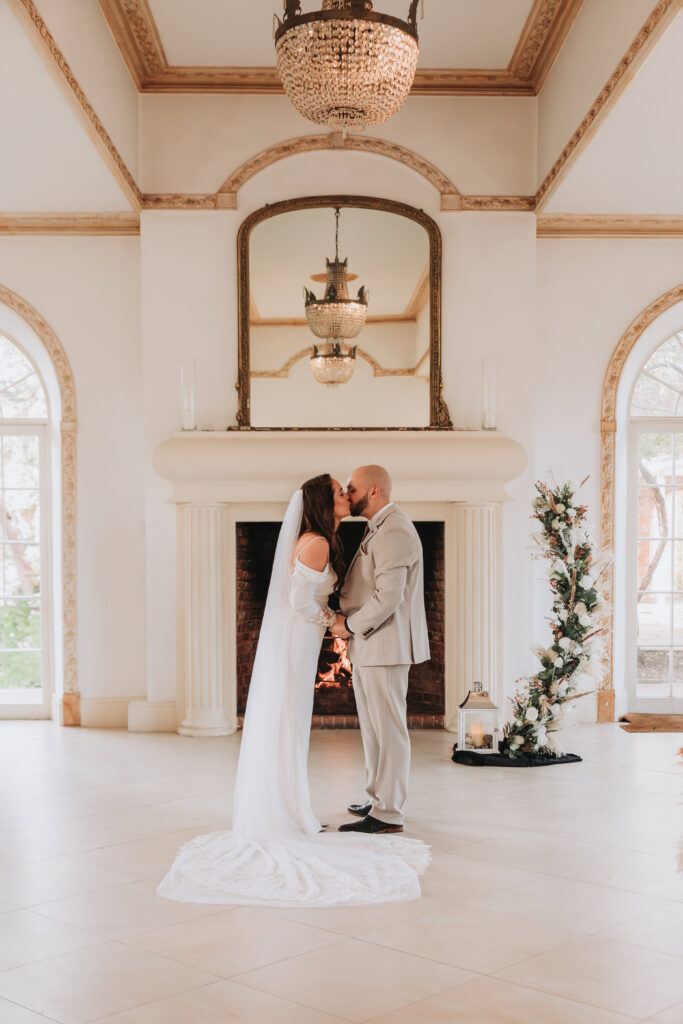 bride and groom kissing at wedding ceremony