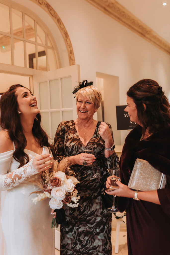 bride laughing with her family during wedding reception