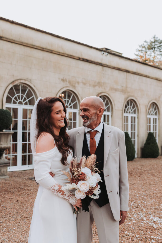 bride laughing with her dad at northbrook park wedding