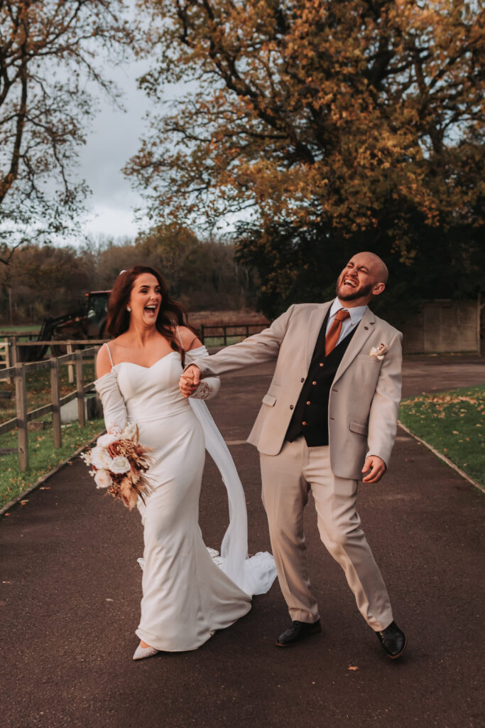 bride and groom walking and laughing at each other