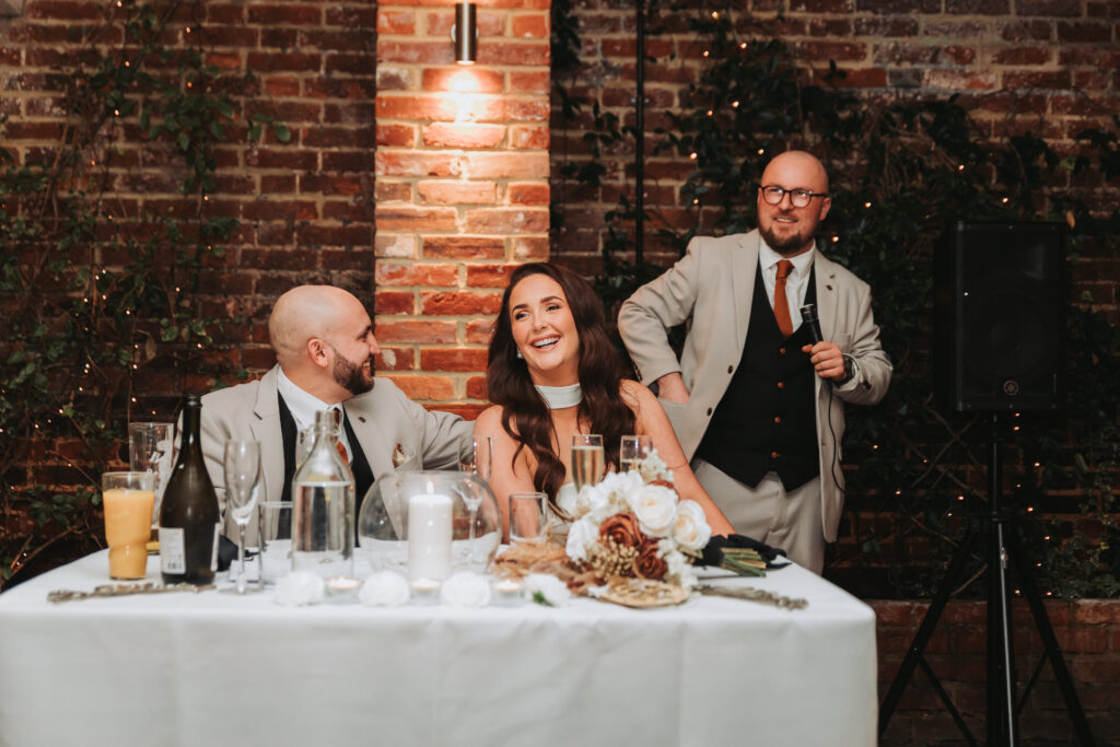 bride laughing at best mans speech
