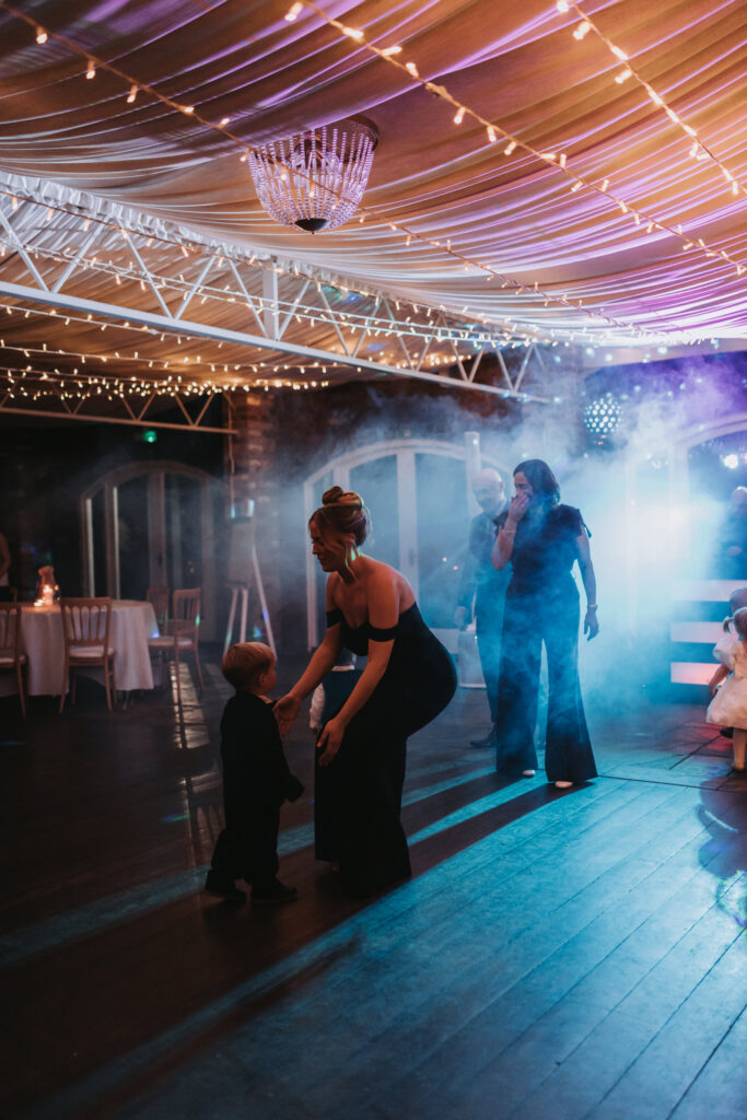 guests dancing on dancefloor with smoke machine