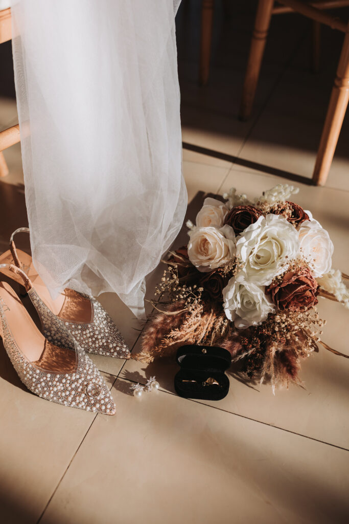 bride veil, shoes and flowers with rings