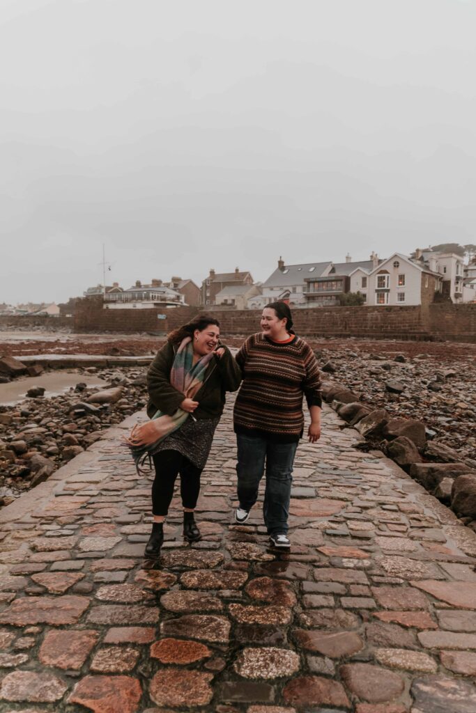 couple walking down a cobbled street together