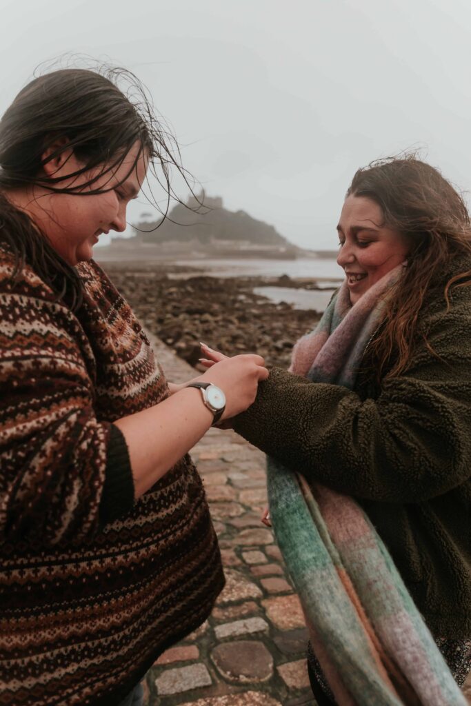 two girls getting engaged and putting rings on