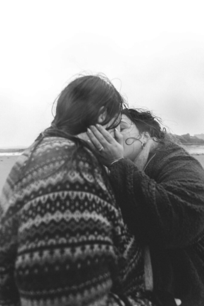 blurry photo of girls kissing after getting engaged close up