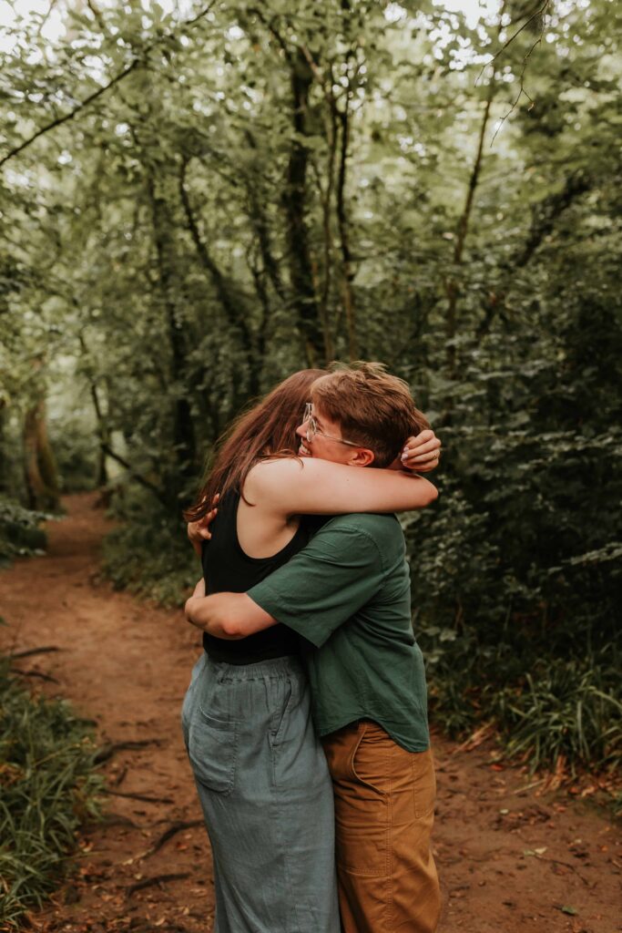 two people hugging after surprise proposal in devon