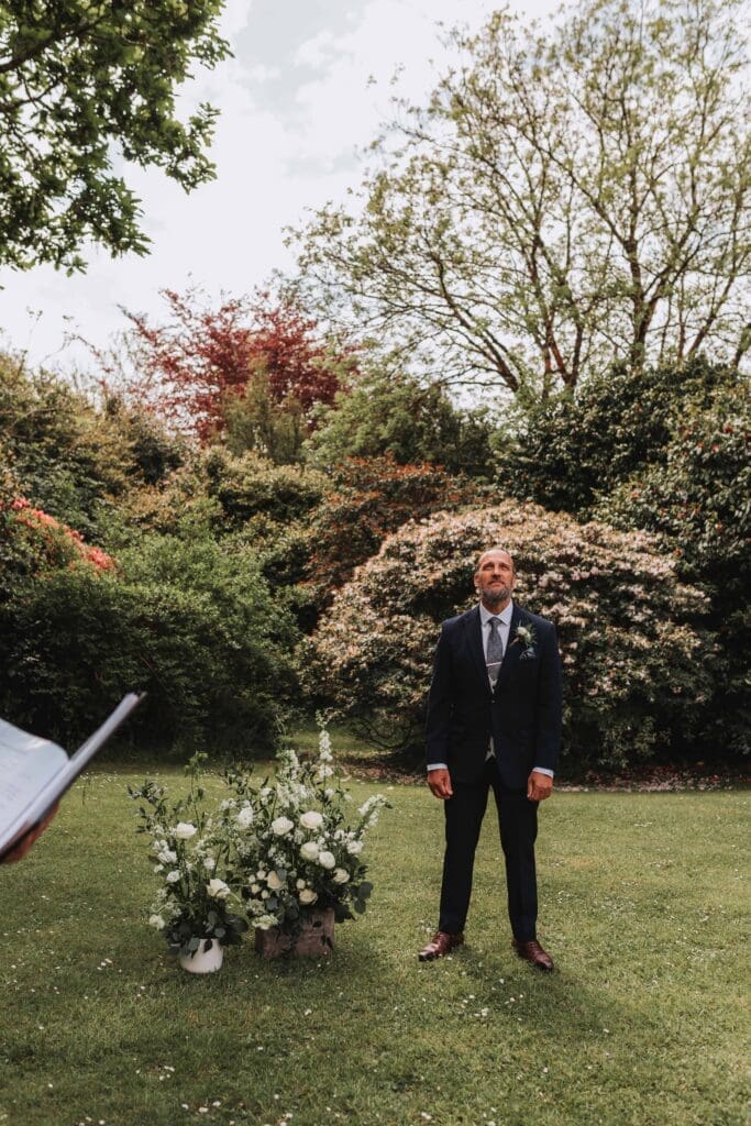 groom waiting for bride at outdoor ceremony