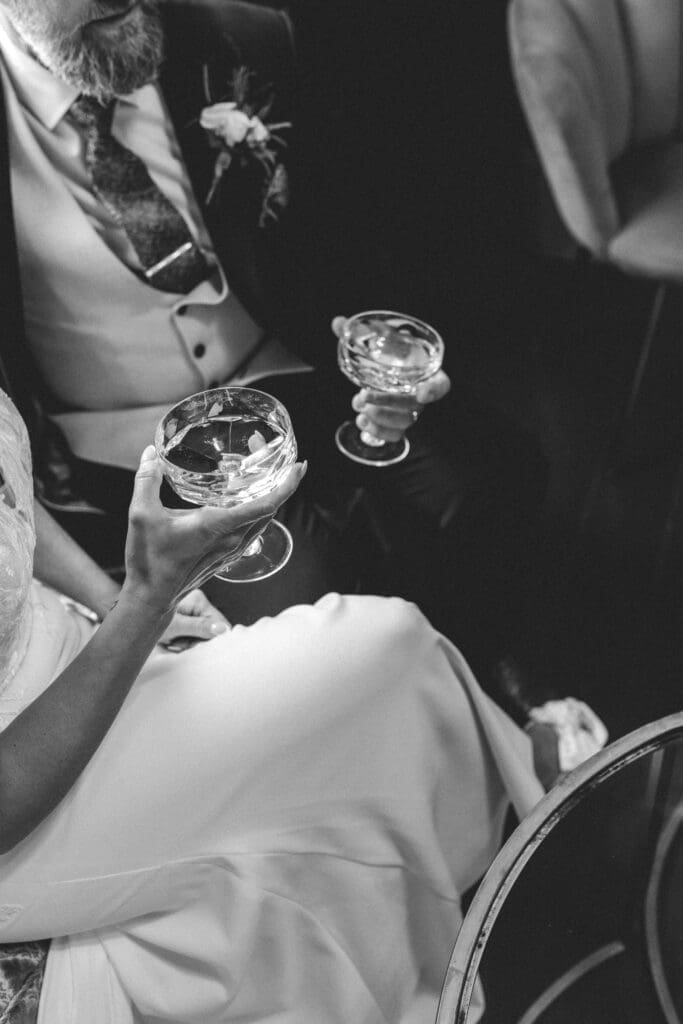 bride and groom holding glasses in bar