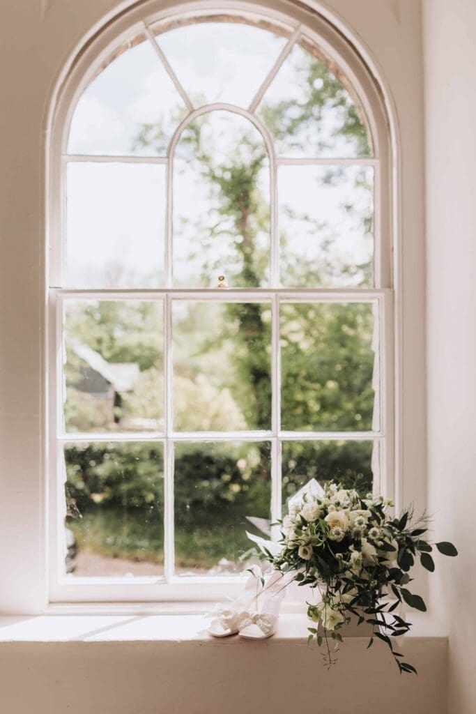 brides bouquet and shoes in treseren window 