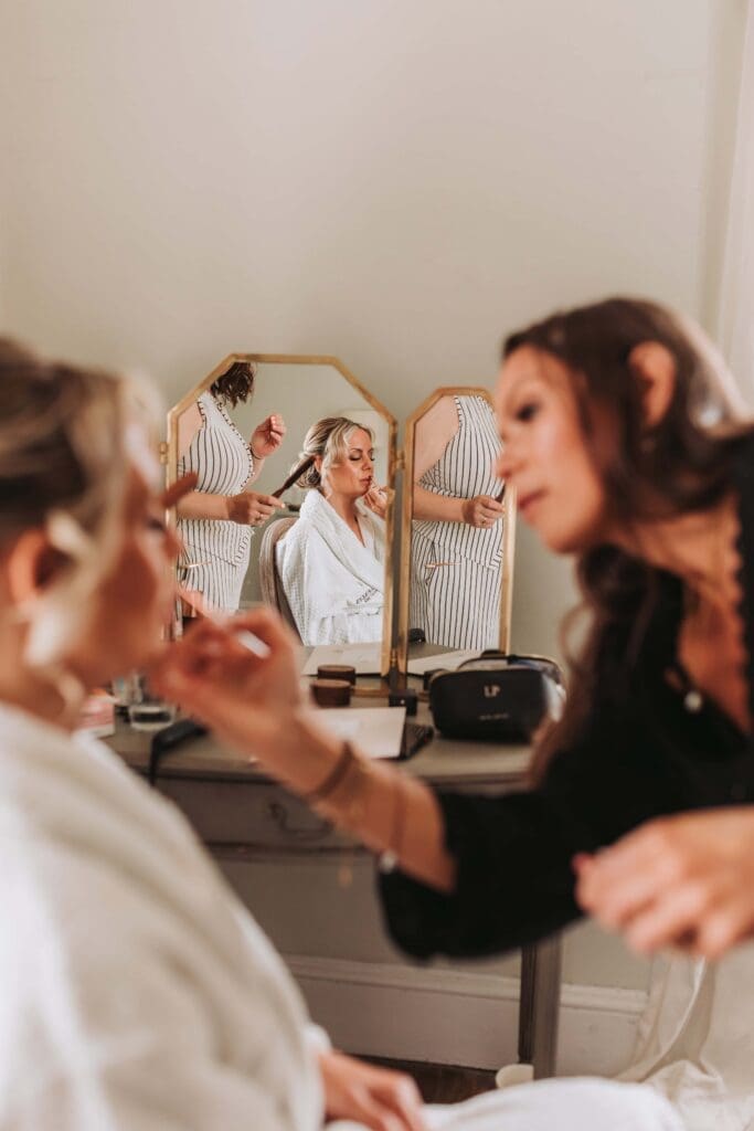 bride having her hair and make up done
