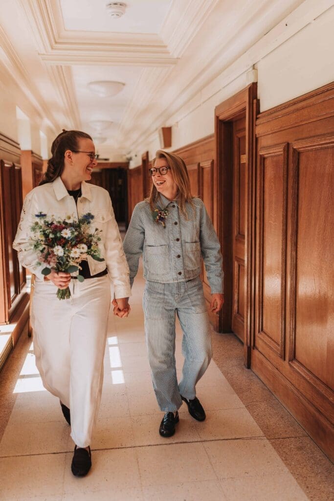 two brides walking down hallway in wandsworth town hall