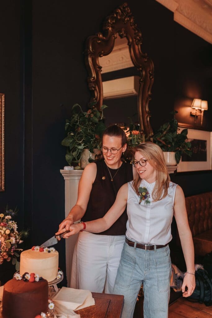two brides cutting cakes
