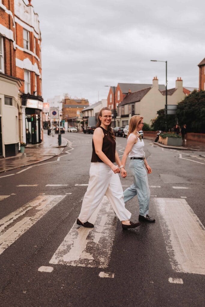 brides walking across zebra crossing