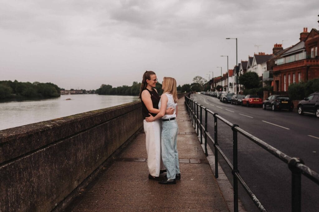 two brides holding each other outside wedding reception