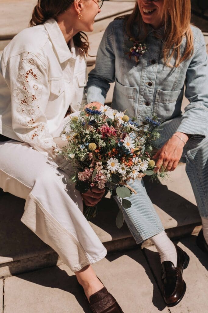 bouquet of flowers held by two brides outside wandsworth town hall