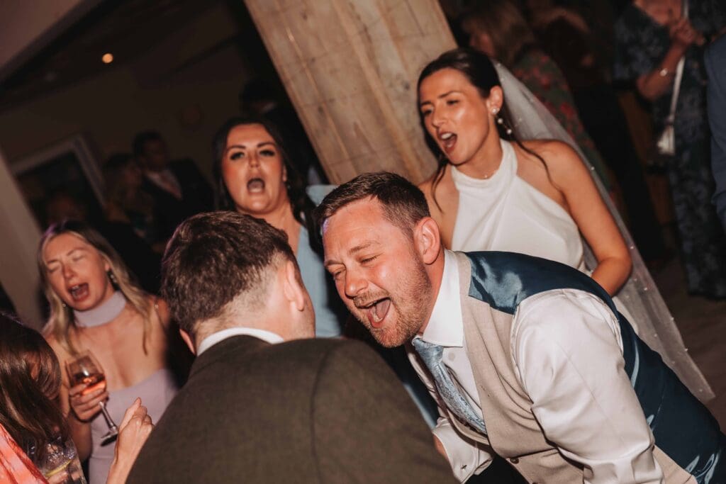 groom singing on wedding dancefloor