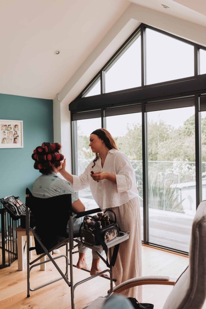 mother of the bride having makeup done at wedding