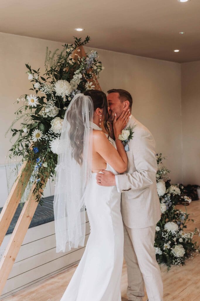 first kiss at beachside wedding