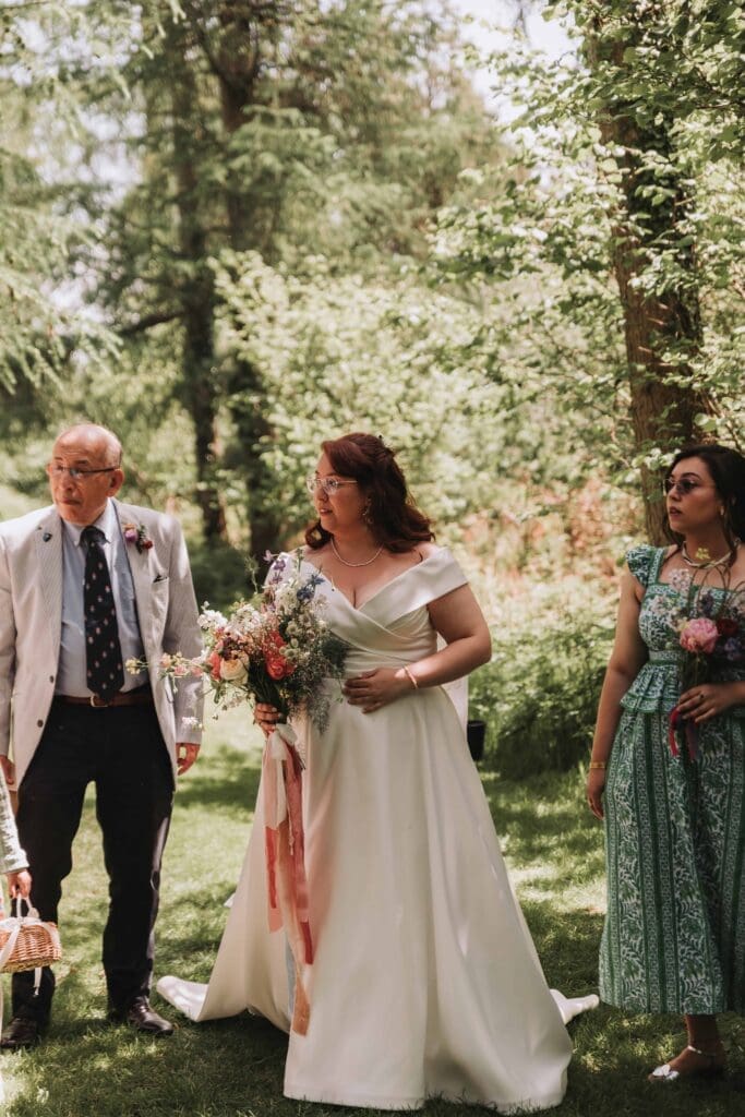 bride stood in woodland before ceremony