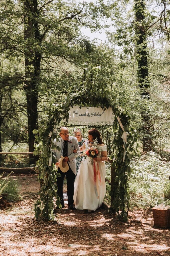 father of the bride walking bride down woodland aisle