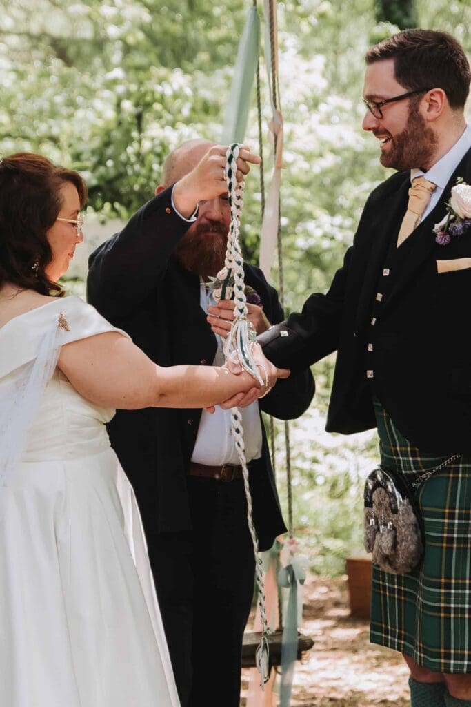 hand fasting at woodland wedding