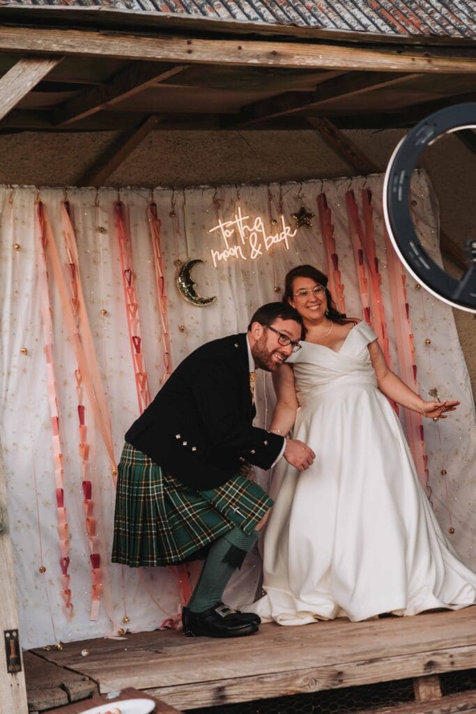 bride and groom in diy photobooth
