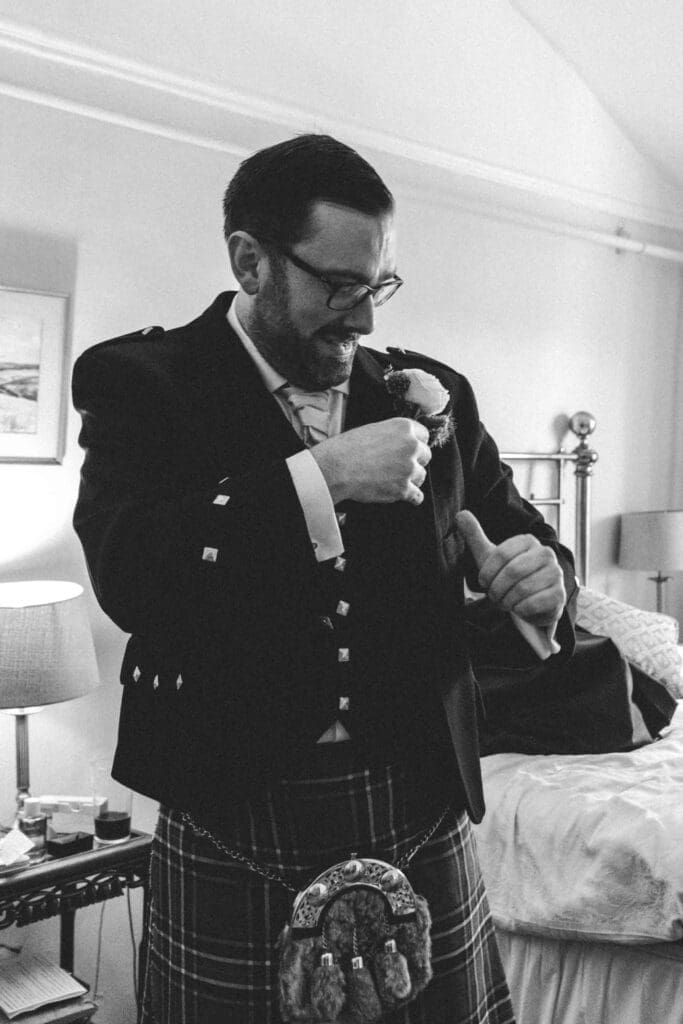 groom adjusting his suit
