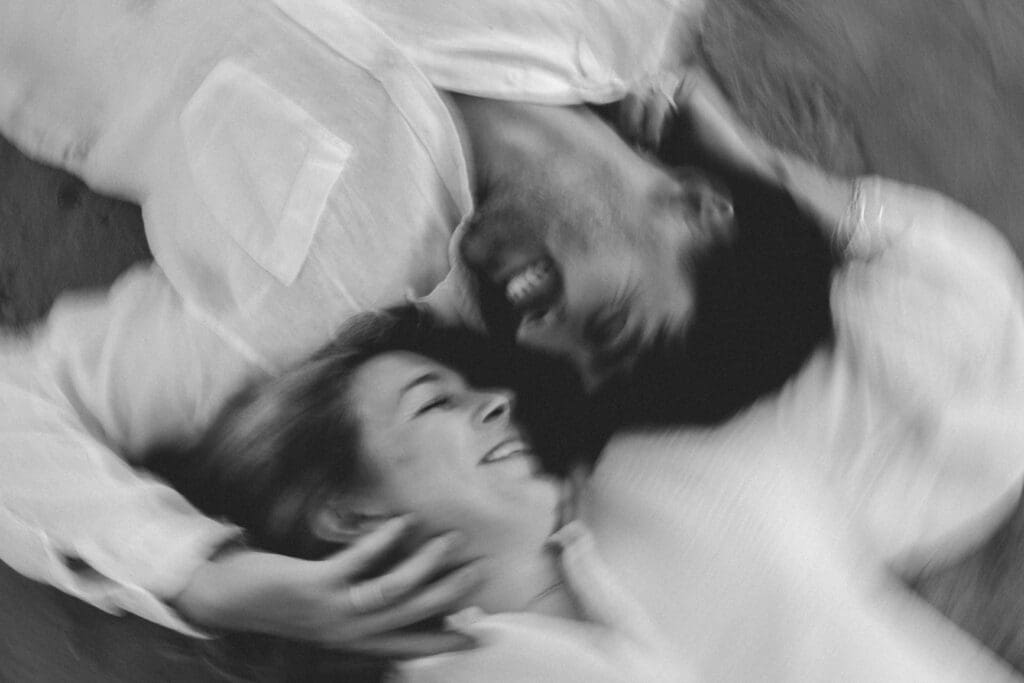 guy and girl laying next to each other on the beach