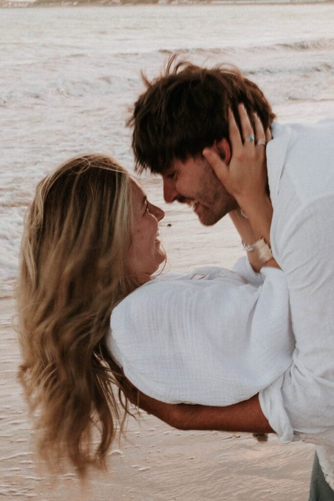 girl and guy laughing with faces close together