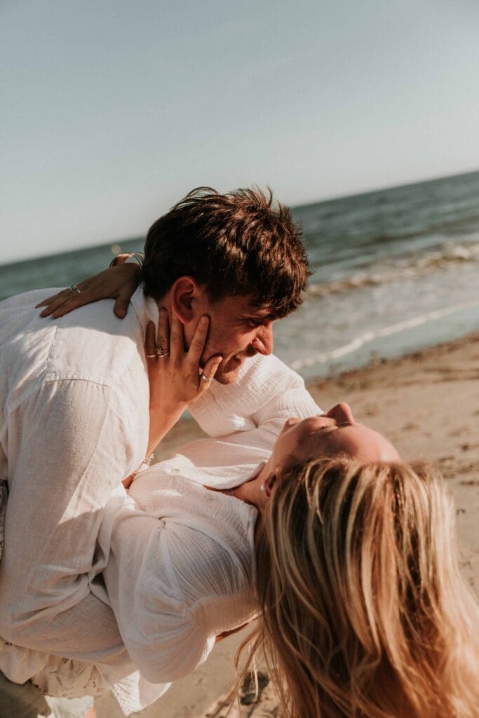 girl and guy acting silly on the beach