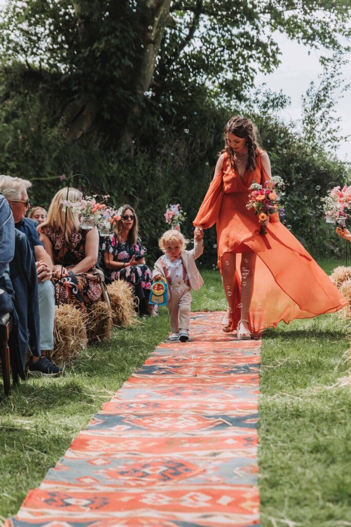 bridesmaid and paige boy walking down aisle