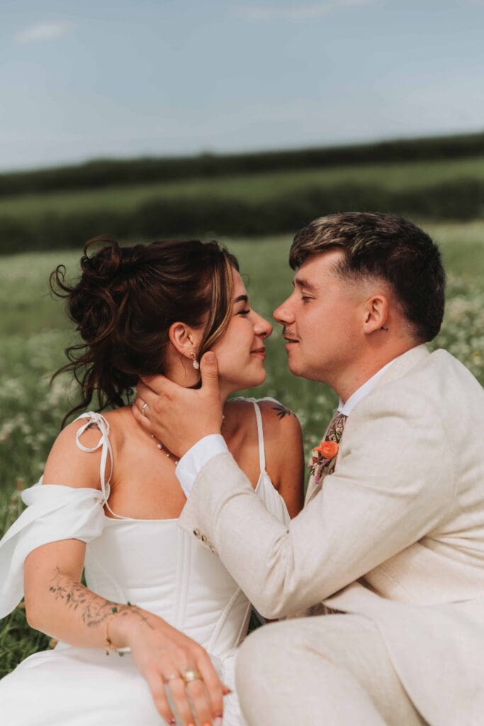 groom kissing bride at holsome park festival wedding